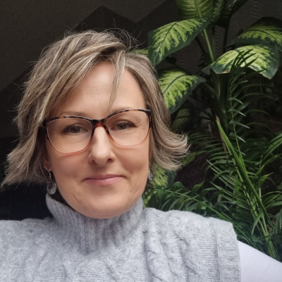 Portrait of Anna, the therapist, smiling gently, conveying warmth, approachability, and empathy.